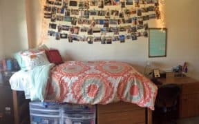 dorm bed with hanging pictures