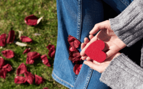 Girl holding a heart with petals